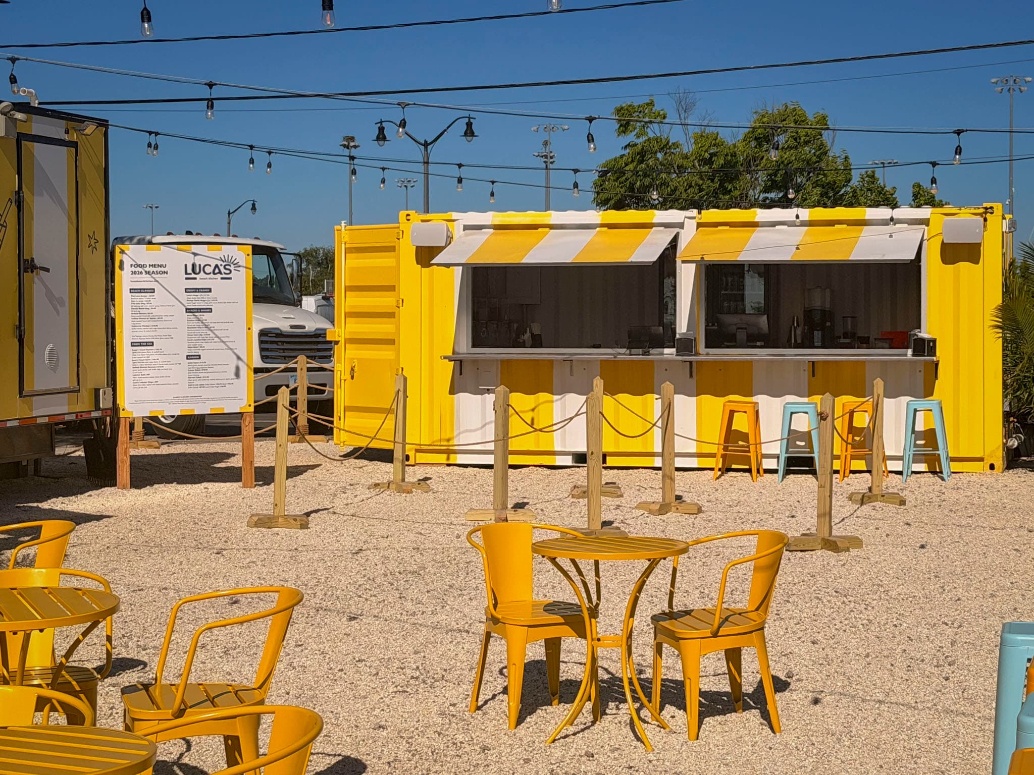 Yellow Luca's service counter with stools and menu sign