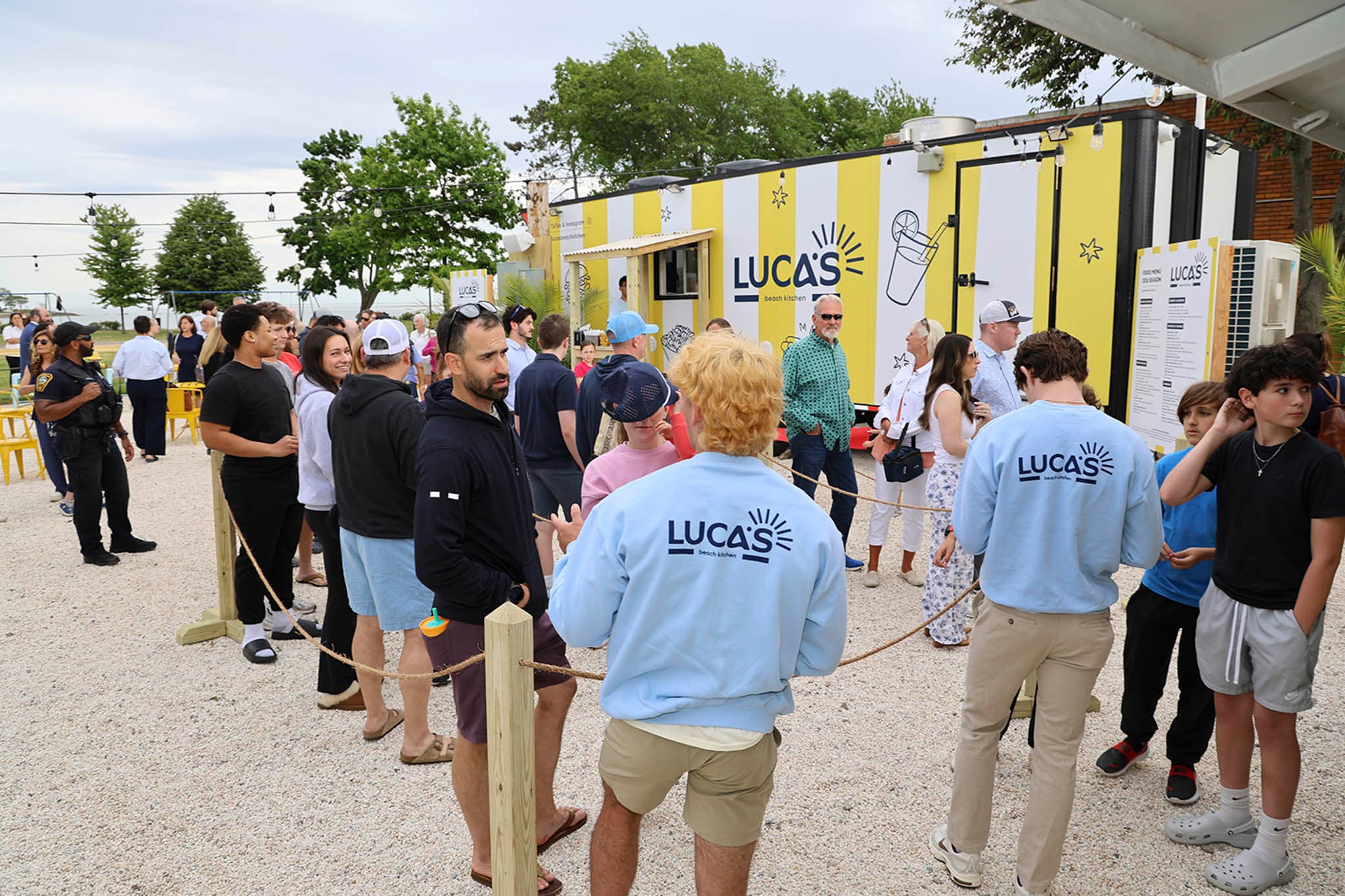 Grand opening guests gathered around the Luca's patio